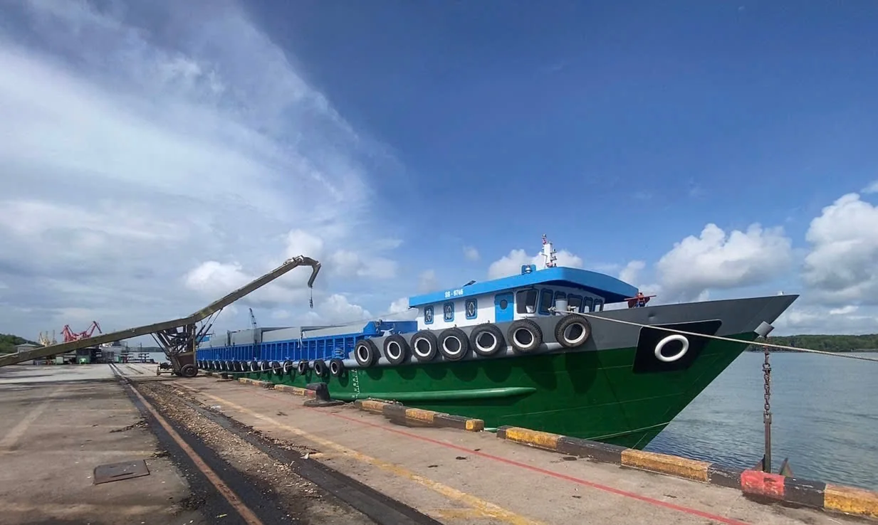 Covered barge navigating a river